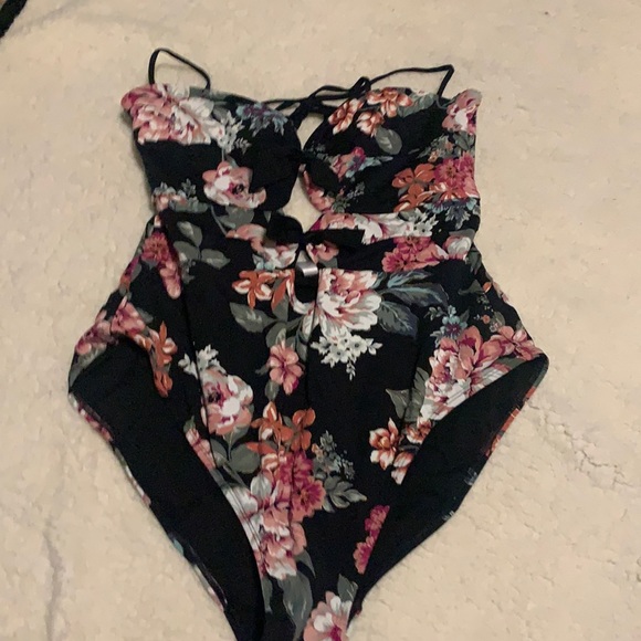 A one-piece bathing suit with a keyhole back and two little peek-a-boo holes - Picture 1 of 4